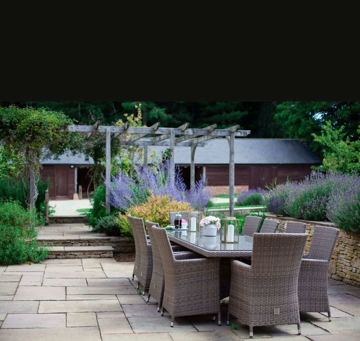 An al fresco dining terrace bordered by lavender