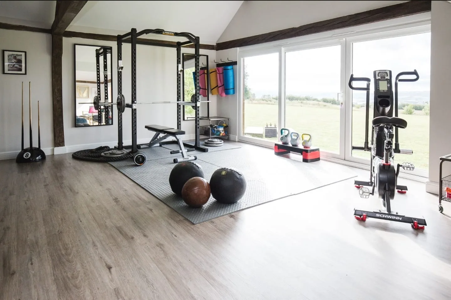 The private studio and gym space, with countryside views through floor-to-ceiling windows