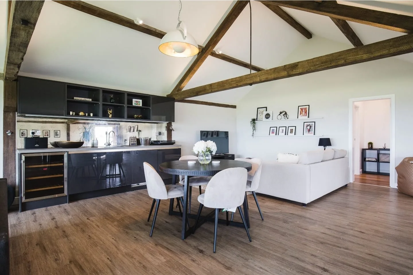 The studio's own kitchen and lounge area, beneath vaulted oak beams
