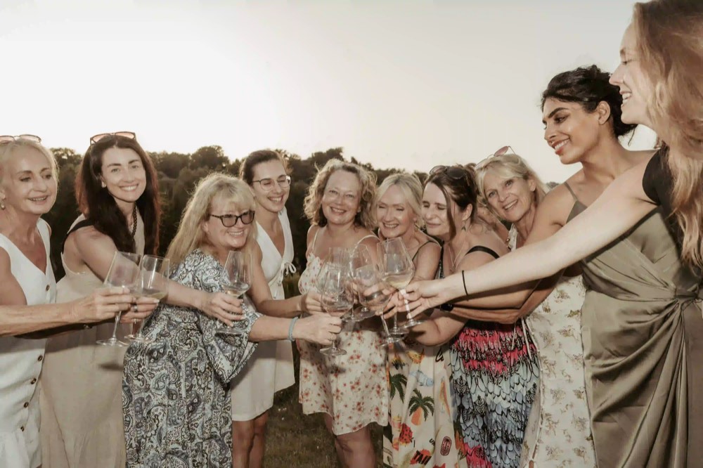 Women raising a toast together outdoors