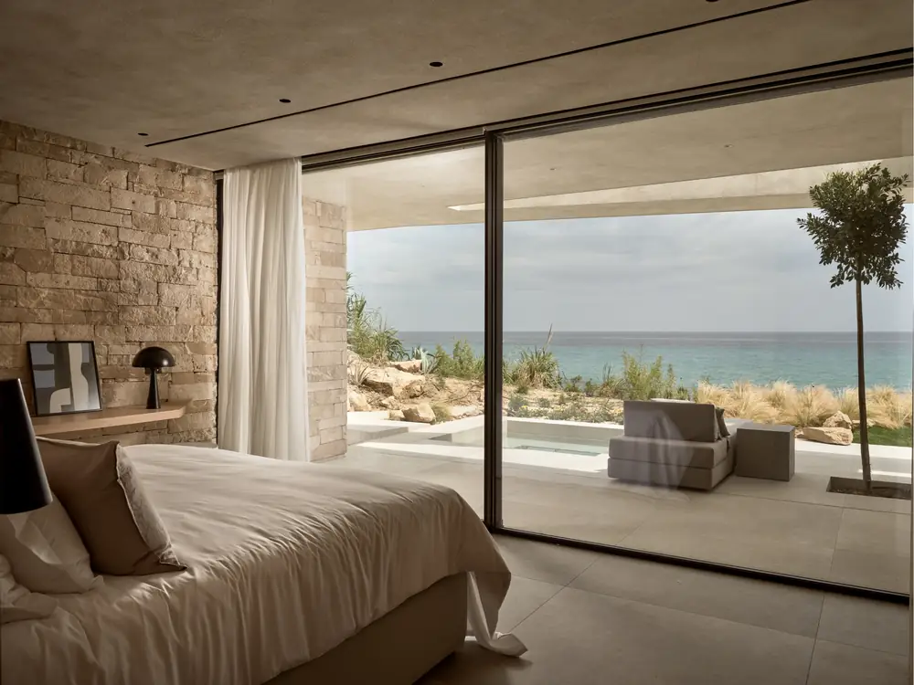 The master suite opening onto the pool terrace with sea views