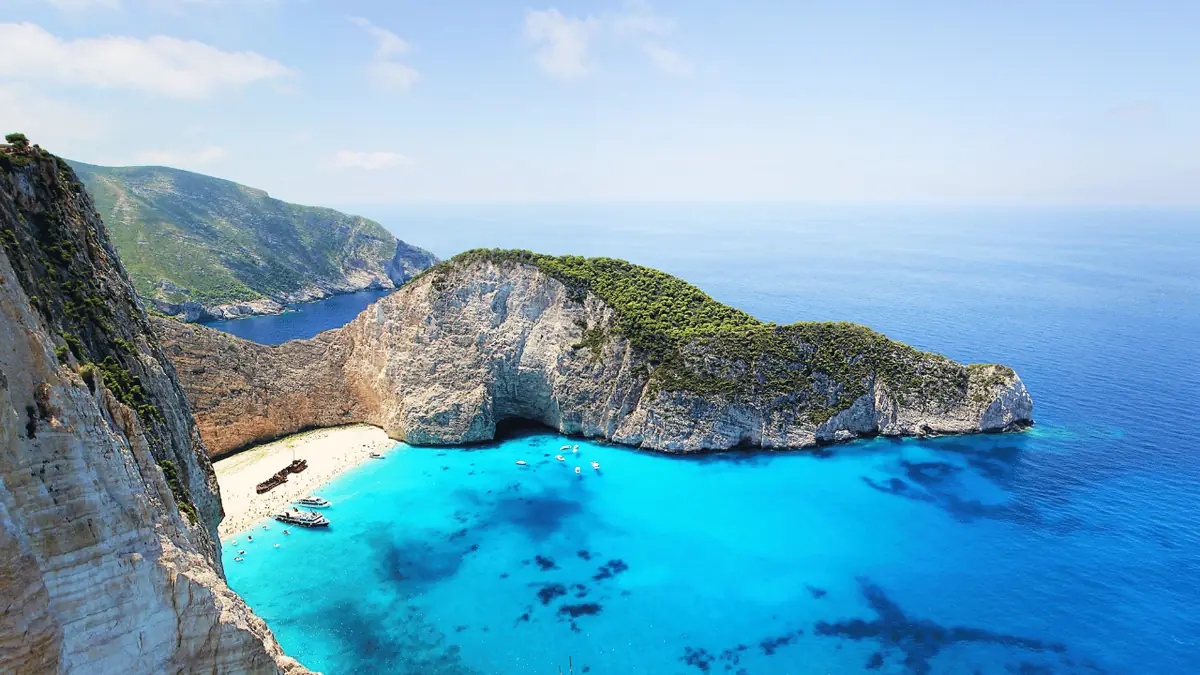 A boat on the clear turquoise water off the Zakynthos coast