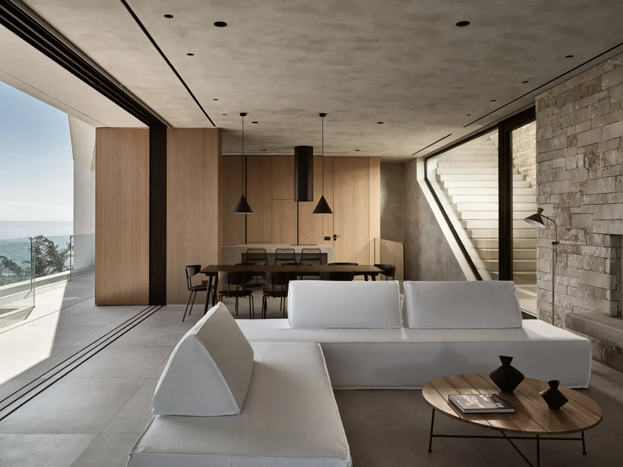 The light-filled living and dining space with sea views