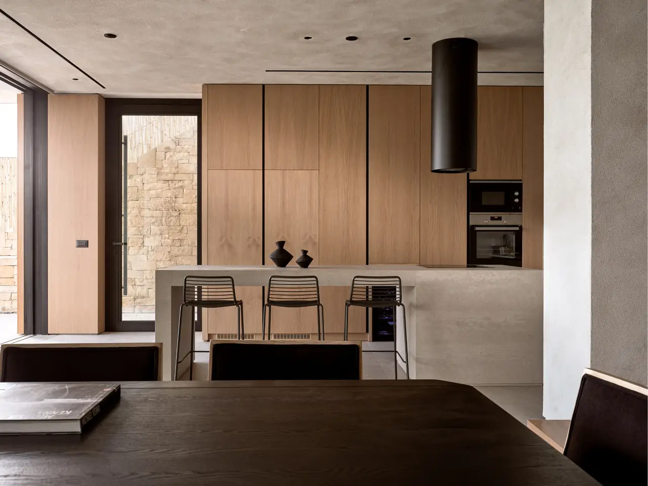 The villa's kitchen in warm oak and stone