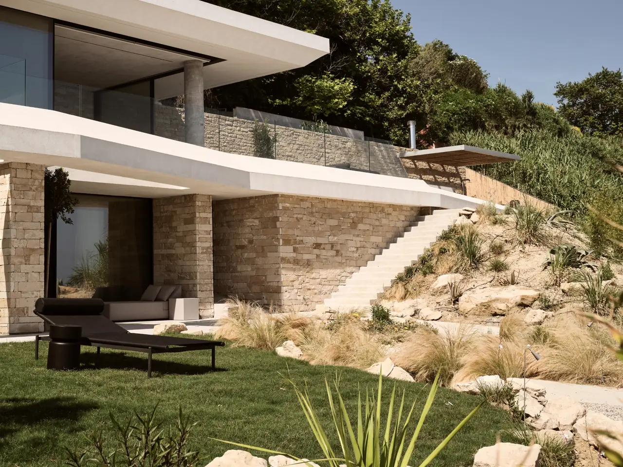 The villa's stone terraces and garden set into the hillside