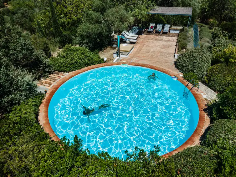 Aerial view of the round pool set among the gardens