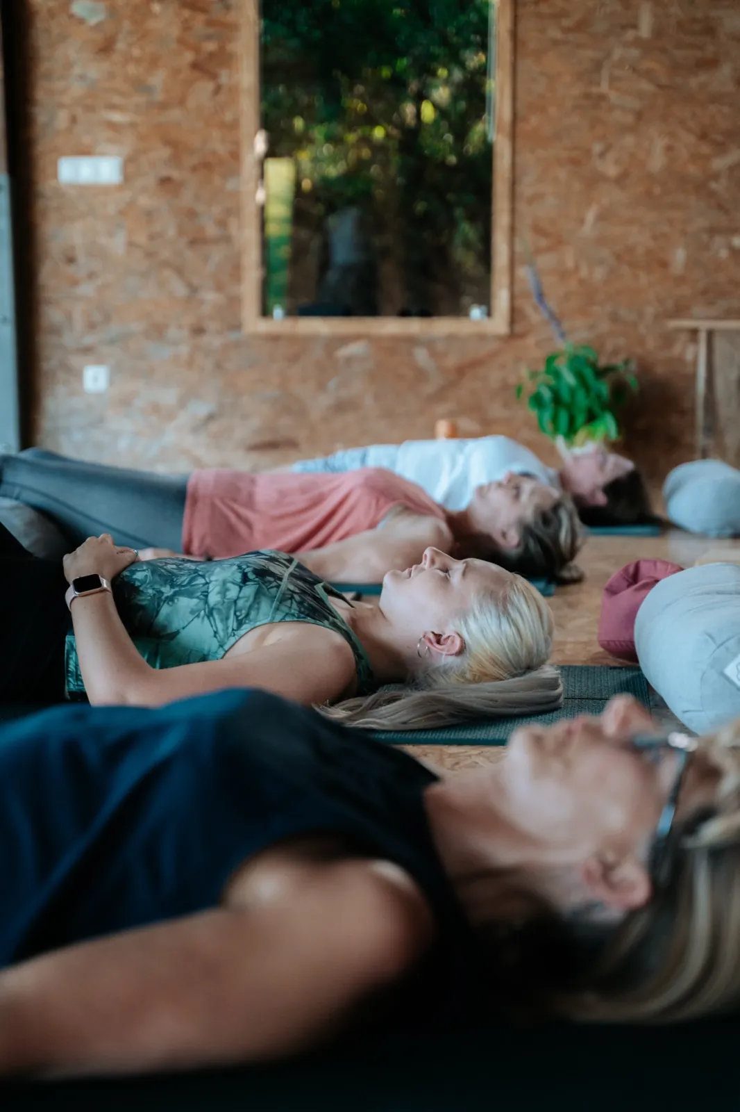 Guests resting on their yoga mats during a relaxation practice at the Portugal retreat